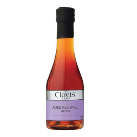 Bottle in glass of Red Wine Vinegar of the Clovis brand, front view.