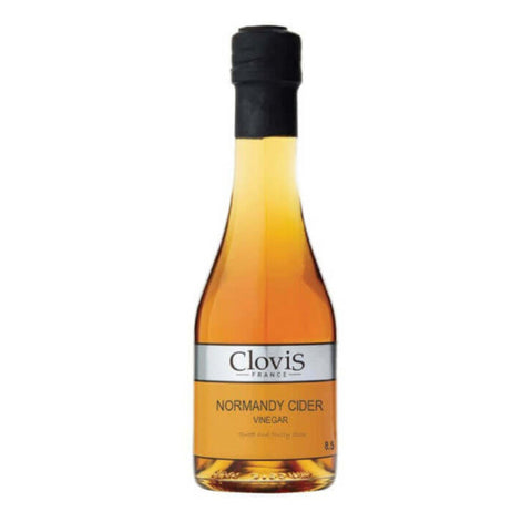 Bottle in glass of Apple Cider Vinegar of the Clovis brand, front view.