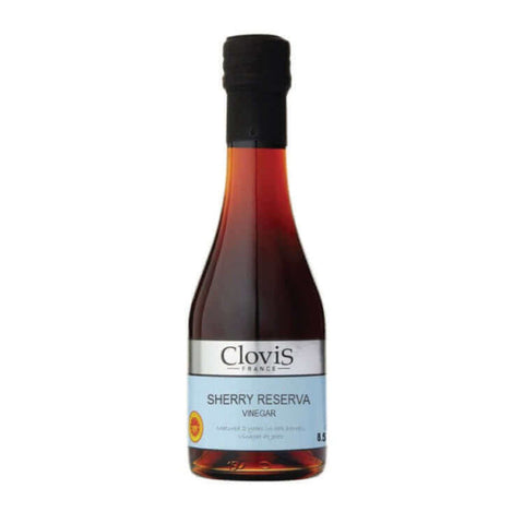 Bottle in glass of Sherry Reserve Vinegar of the Clovis brand, seen of face.