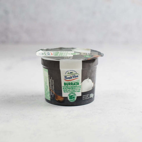 Plastic pot containing Italian Frozen Buratta on marble, side view.