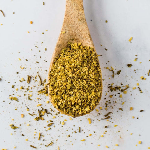 Wooden spoon containing Vegetable Spice Blend, seen from above.