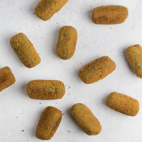 Assortments of Spinach and Pine Nuts Croquettes placed on marble, seen from above. 