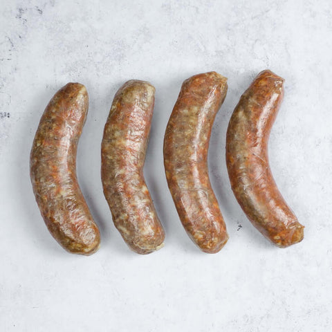 Assortment of four Chorizo Spanish Style Sausage arranged on marble, seen from above.