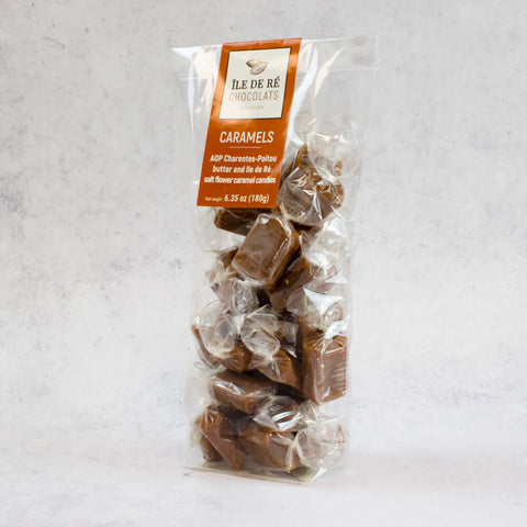 Assortments of Salted Caramel in Bags from the Ile De R?? Chocolats brand, arranged in a plastic bag, side view. 