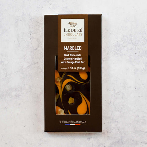 Dark Chocolate Orange Marbled with Orange Peel Bar from the brand Ile De R?? Chocolats, arranged in their box, front view.