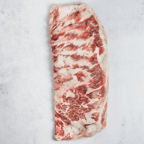 1 Ibérico Pork Spare Ribs 3lbs set on marble, seen from above.