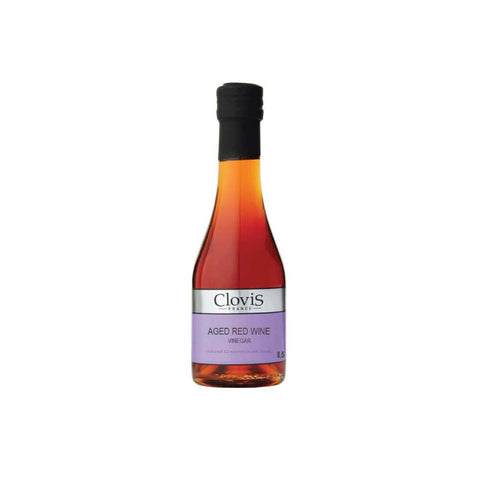 Bottle in glass of Red Wine Vinegar of the Clovis brand, front view. 