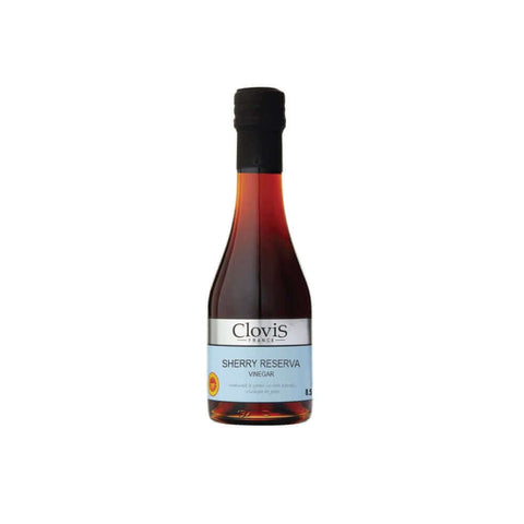 Bottle in glass of Sherry Reserve Vinegar of the Clovis brand, seen of face. 