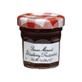 Glass jar of Strawberry Preserves from the Bonne Maman brand, seen from the front.
