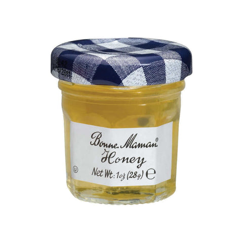 Glass jar of Honey from the Bonne Maman brand, seen from the front.