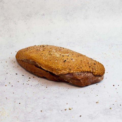 Whole Smoked Duck Breast, seasoned with salt and pepper, front view.