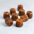 Assortment of Cannelés from Bordeaux, set on marble, front view. 