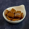 Assortments of Salted Caramel in Bags arranged in a bowl, side view. 