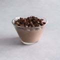 Coppa Chocolate Mousse served in a glass bowl on marble, front view.
