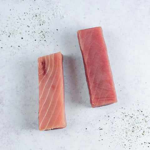 2 Yellowfin Saku Wild Tuna arranged on marble, seen from above.