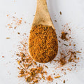 Wooden spoon containing Steakhouse Spice Blend, seen from above.