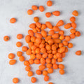 Assorted Parisian Carrots arranged on marble, seen from above. 