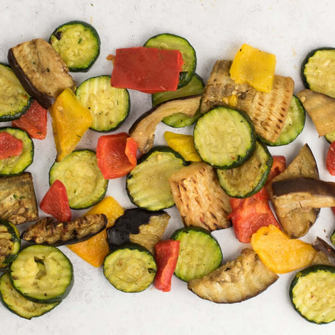 Assorted Mixed Grilled Vegetables arranged on marble, seen from above. 