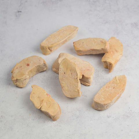 Slices of Foie Gras arranged on marble, seen from above. 