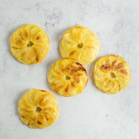 5 Potato Anna sliced on marble, seen from above.