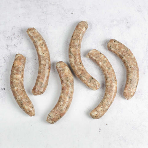 6 Chipolata Bistro Sausage arranged on marble, seen from above.