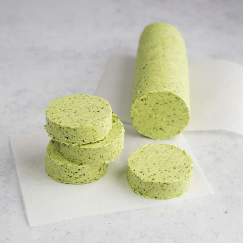 Garlic & Herbs Butter Roll sliced and placed on a sheet of baking paper on marble, seen from above. 