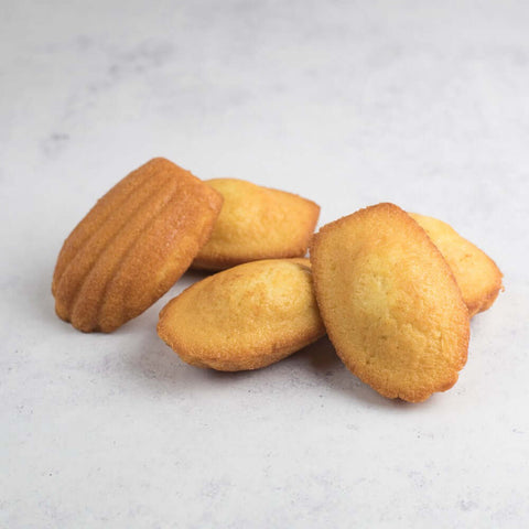 Assorted Pure Butter Madeleines, arranged on marble, seen above. 
