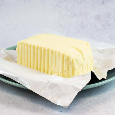 The Gall Butter Block Unsalted opened and arranged on a plate, side view. 