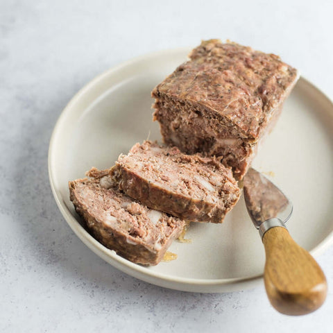 Pate de Campagne (Pork Pate Country Style) sliced and arranged in a round plate, seen from above. 