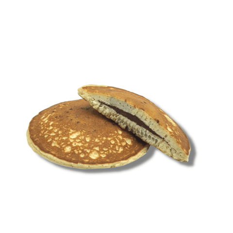 Chocolate and Hazelnut Filled Pancake filling, one cut in half, placed on a marble, front view.