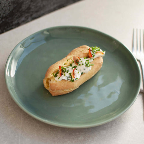 French Quenelle Buns arranged in a round plate, seen from above. 