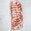 1 Ibérico Pork Spare Ribs 3lbs set on marble, seen from above.