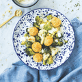 Cauliflower and Broccoli Veggie Mix cooked in a round plate on marble, seen from above.