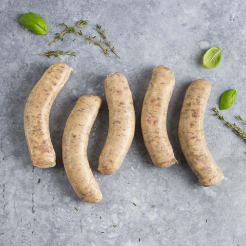 1 pack of 5 pcs Toulouse Sausage on marble with some thyme, seen from above.