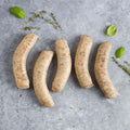 1 pack of 5 pcs Toulouse Sausage on marble with some thyme, seen from above.