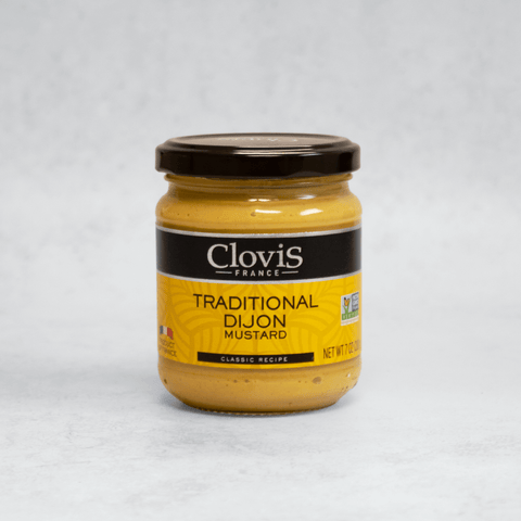 Glass jar containing Dijon Mustard from Clovis, front view. 
