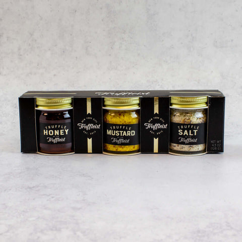 Mini Truffle Trio Gift Set with Truffle Honey, Truffle Mustard and Truffle Salt, in their cardboard box, front view.