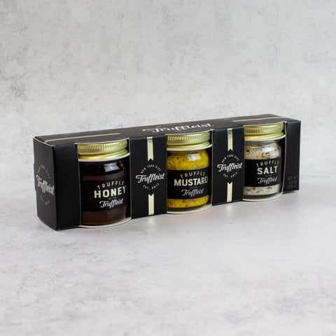 Mini Truffle Trio Gift Set with Truffle Honey, Truffle Mustard and Truffle Salt, in their cardboard box, side view.